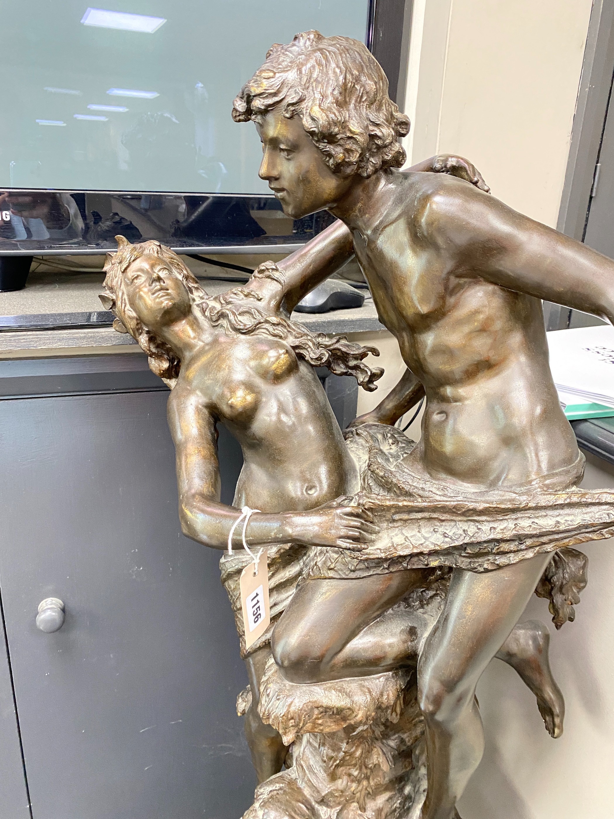 A bronzed metal group of a dancing couple on associated wood plinth combined height 170cm